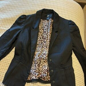 Excellent condition. Black blazer with leopard print lining.